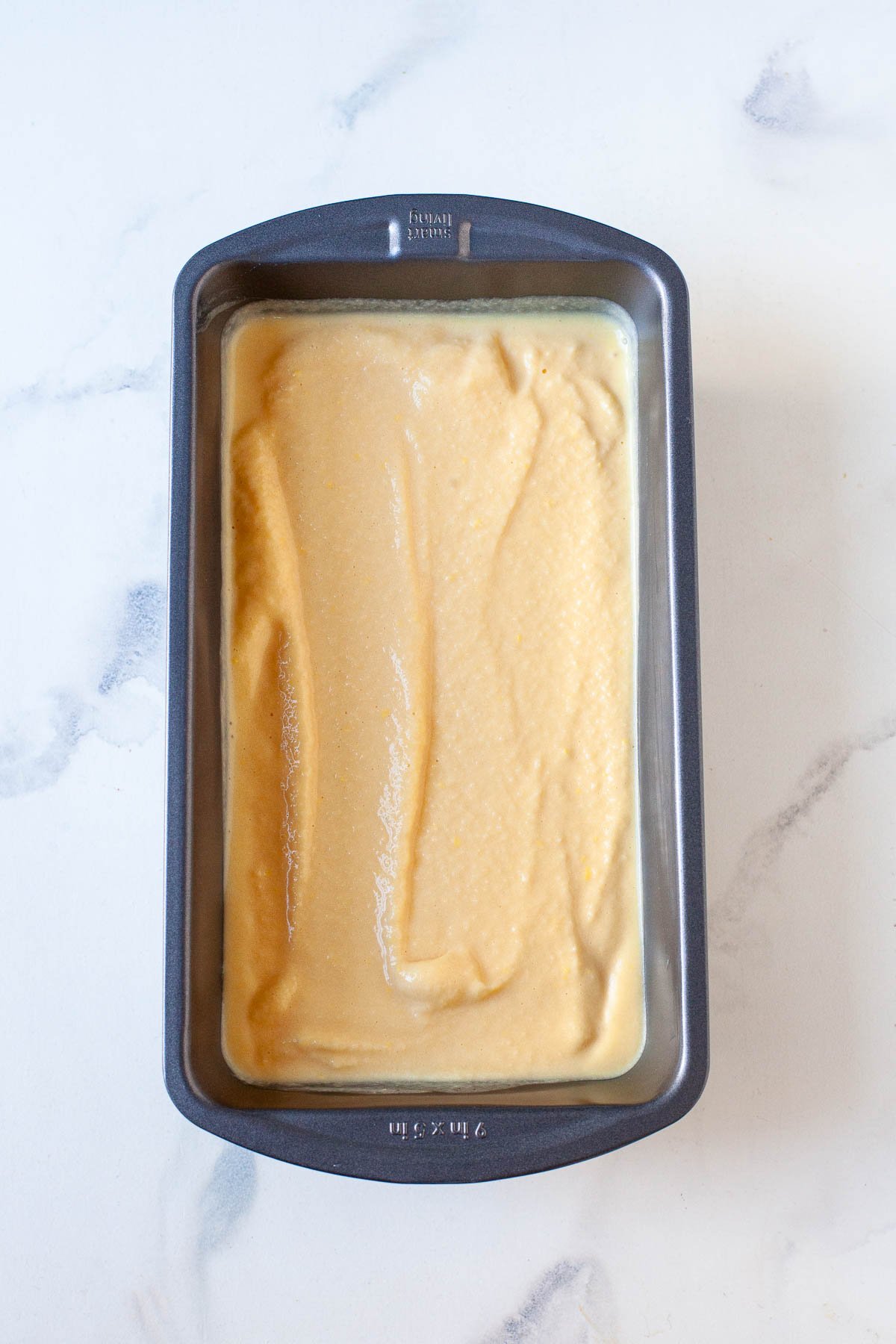 soft serve peach ice cream in gray loaf pan